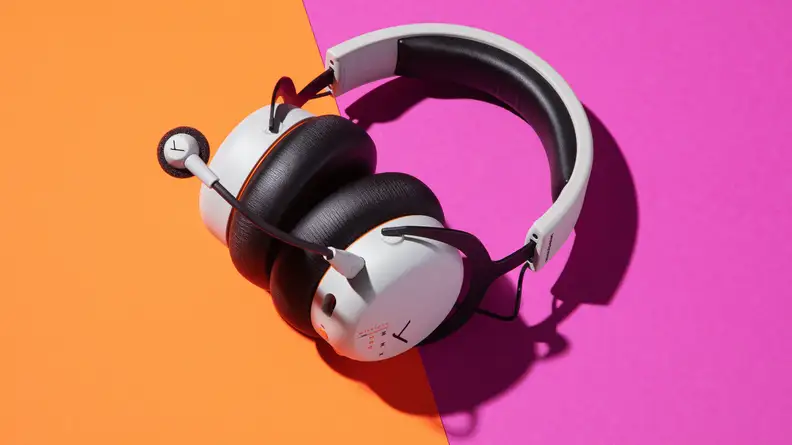 A white gaming headset with extended mic arm and orange buttons