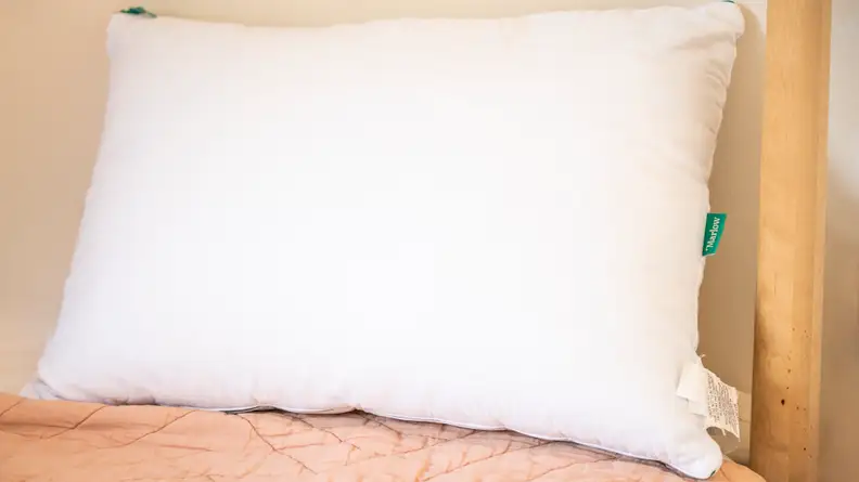 marlow pillow sitting on bed against headrest