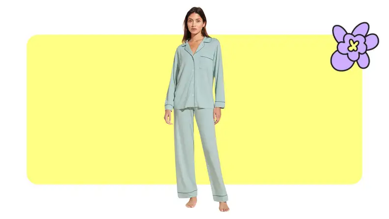 Model showcasing a set of Eberjey pajamas in Surf Spray/Agave color in front of a yellow background with a purple cartoon flower.