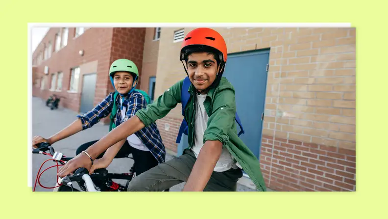 A group of teens on bikes wearing helmets while parked.