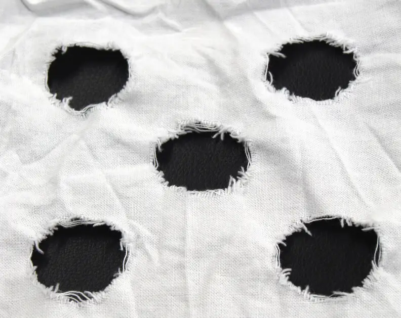 This is an example of a used mechanical action strip. The frayed strains within the circles are tallied up to determine the amount of clothes wear.