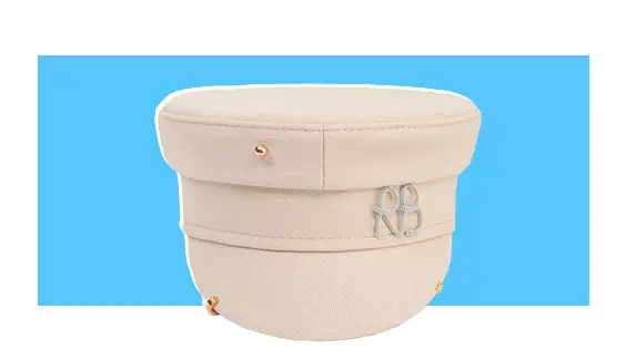 A cream-colored hat with gold piercings.