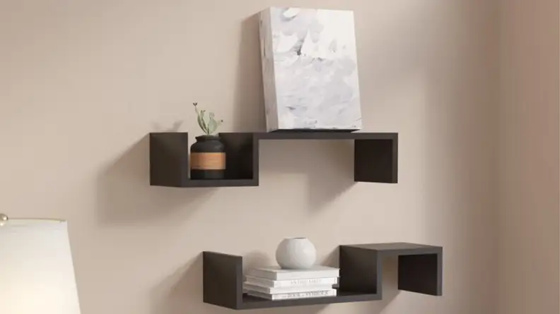 Two floating shelves with square cut outs.
