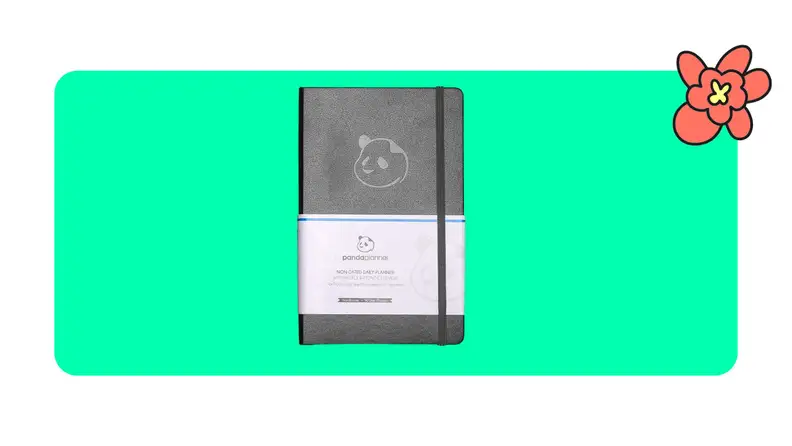 Black productivity journal on green background