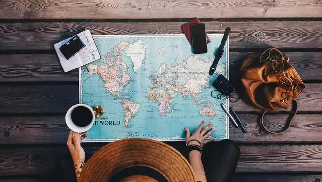 A person looks over a world map.