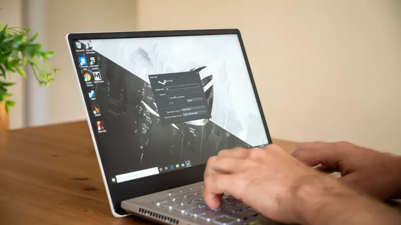A picture of a person typing on the G14
