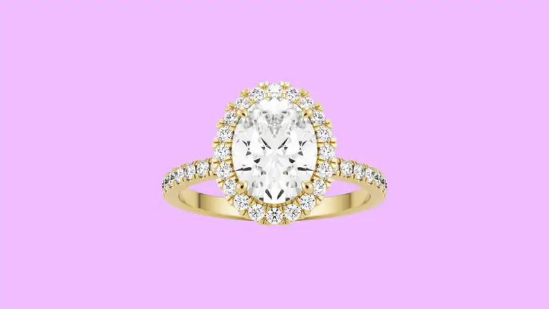 Photo of the Gema & Co. Oval Halo Palé moissanite engagement ring against a purple background.
