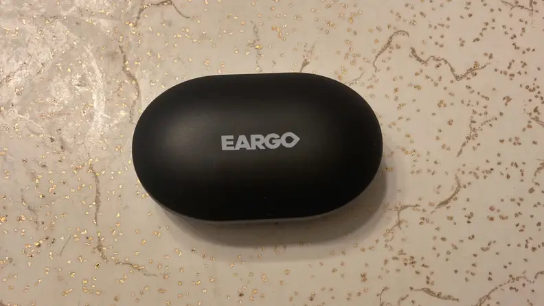 Link by Eargo charging case on a countertop.