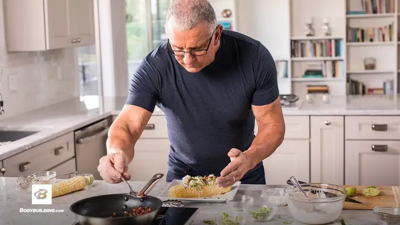 Robert Irvine cooking a meal in kitchen