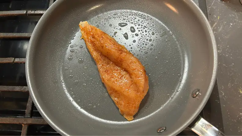 We tested this All-Clad nonstick pan by cooking a variety of foods, including this chicken breast.