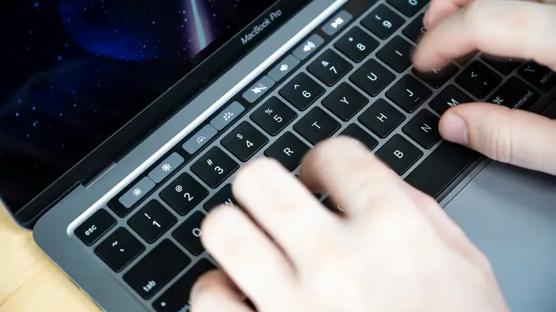 A person types on the keyboard.