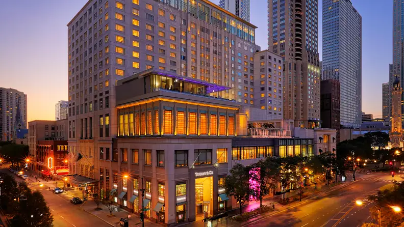 A luxury hotel on a street corner in a big city