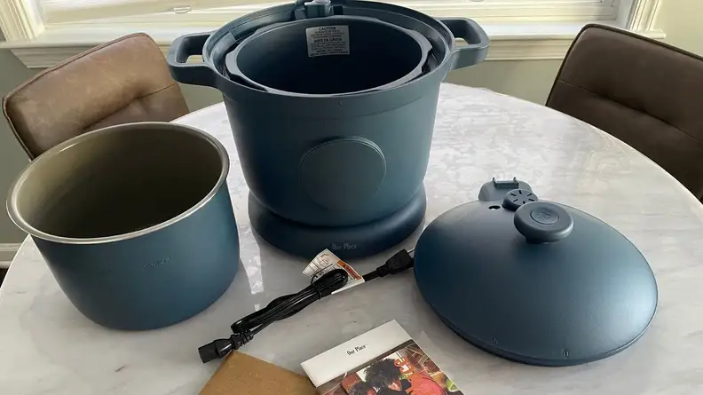 Disassembled Our Place Dream Cooker in Blue Salt color on countertop surface.