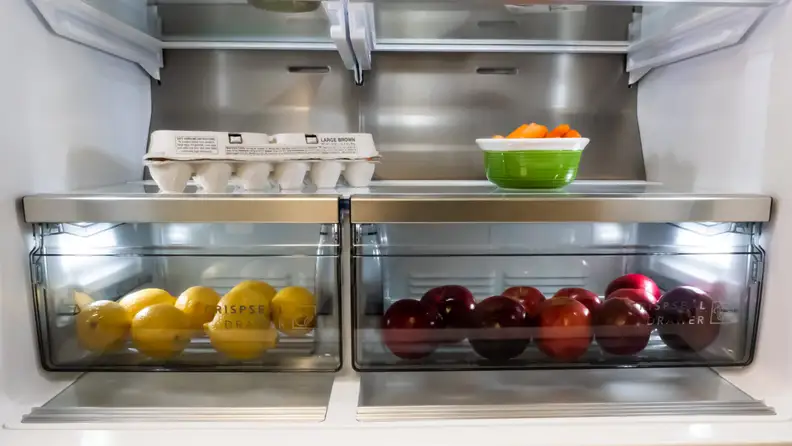 A close-up of the Frigidaire Pro PRMC2285AF counter-depth French-door refrigerator's crisper drawers, which are clear plastic with a strip of stainless steel on their handles.