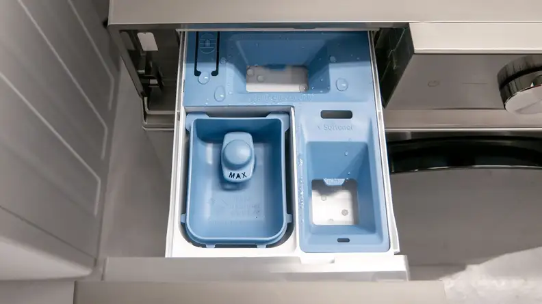 View of the three compartment detergent dispenser inside of the amsung WF53BB8700AT Front-load Washing Machine.