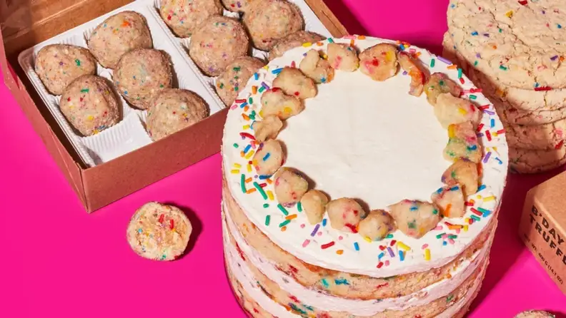 Funfetti birthday cake, funfetti cookies, and funfetti truffles on a neon pink surface.