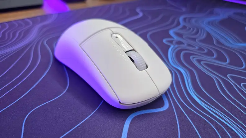 Close up angled view of the Turtle Beach Burst II Air mouse on top of a purple and blue patterned mousepad.