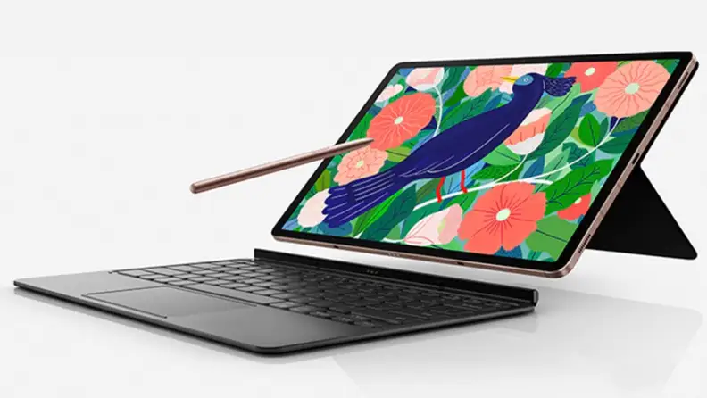 Tablet with keyboard and stylus in front of white background.