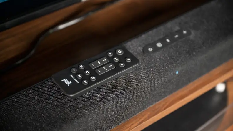 The Signa S4 remote sitting on top of the soundbar