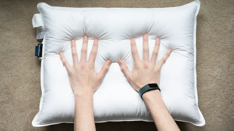 hands press into a Brooklinen pillow
