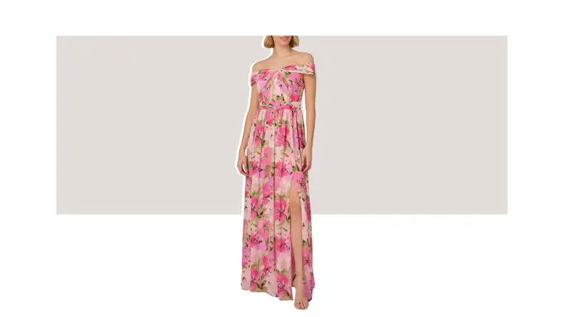 A model wearing an off-the-shoulder floral maxi gown with a leg slit.