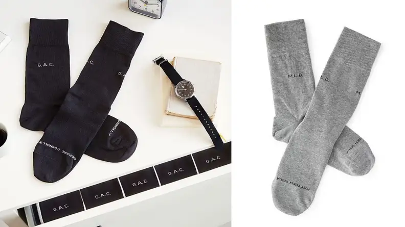 a pair of socks with personalized writing on them