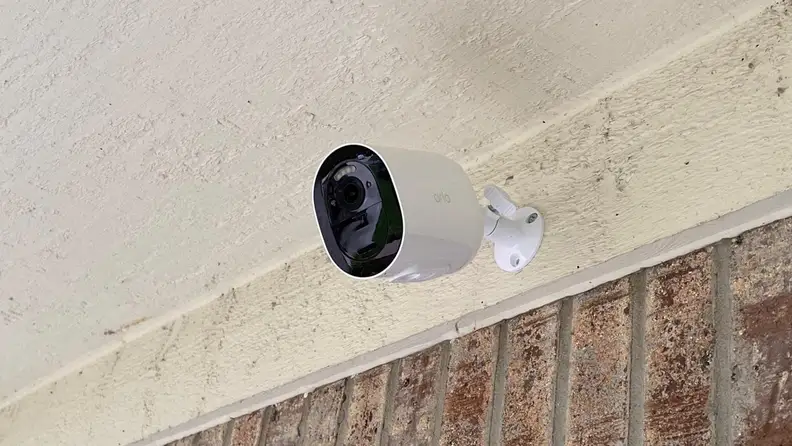 The camera mounted on a wall outside a house.