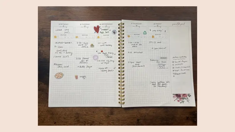 open journal on pink background