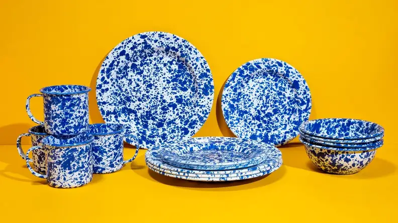 Blue speckled dinnerware set with a bright yellow background.