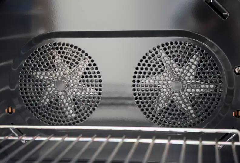 Two convection fans at back of cavity