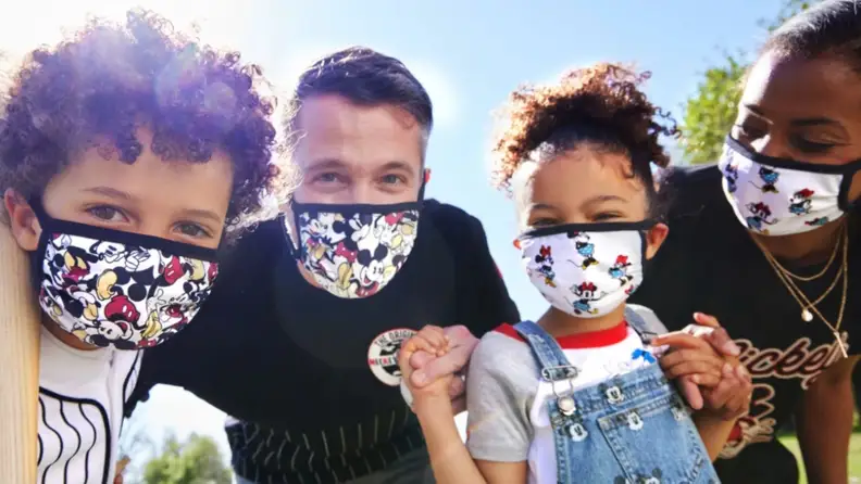 A family of four in Disney-themed PPE masks.