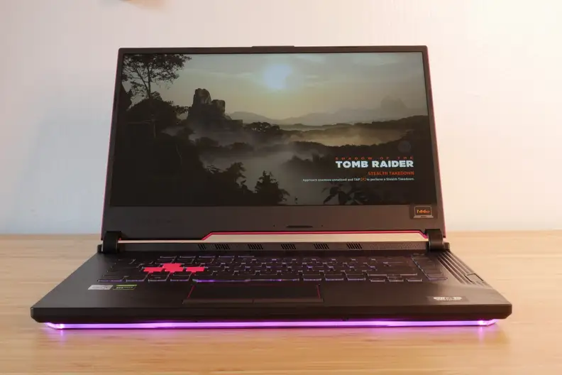 A photo of the Asus ROG Strix G512LI gaming laptop on a desk with display shown