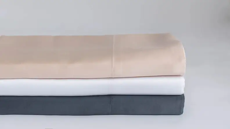 blush, white, and charcoal sheets stacked