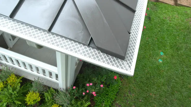 Close-up of roof edge with LeafFilter-style micro-mesh gutter guard covering the gutter.