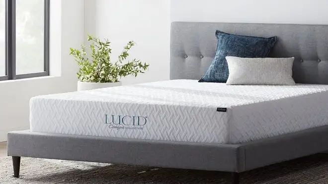 Mattress sitting on bed frame in bedroom setting.