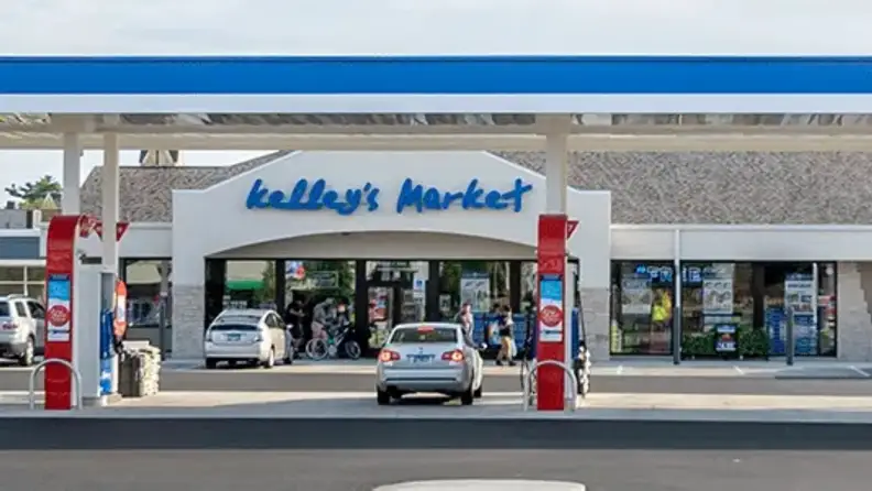 Exterior of a Kelley's Market storefront with fuel pumps and customers
