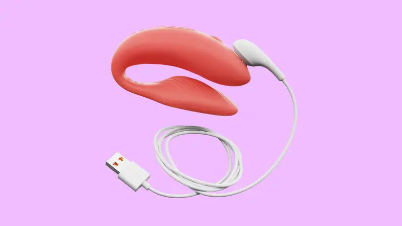 A We-Vibe Chorus connected to a USB charger on a purple background.