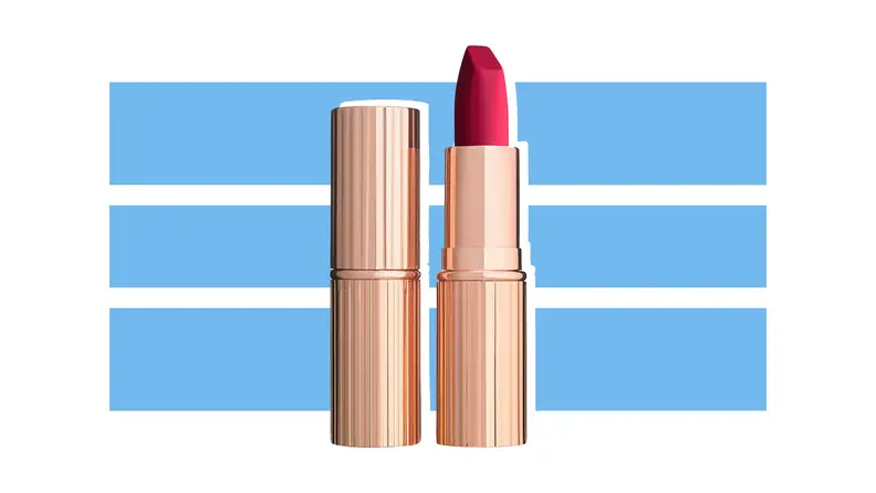 Charlotte Tilbury Matte Revolution Lipstick in Pillow Talk against a blue and white background.