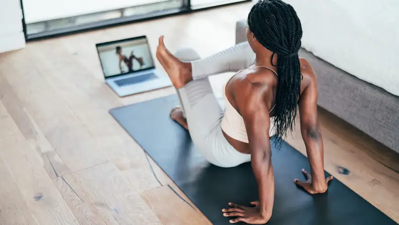 woman practicing yoga with alo moves.