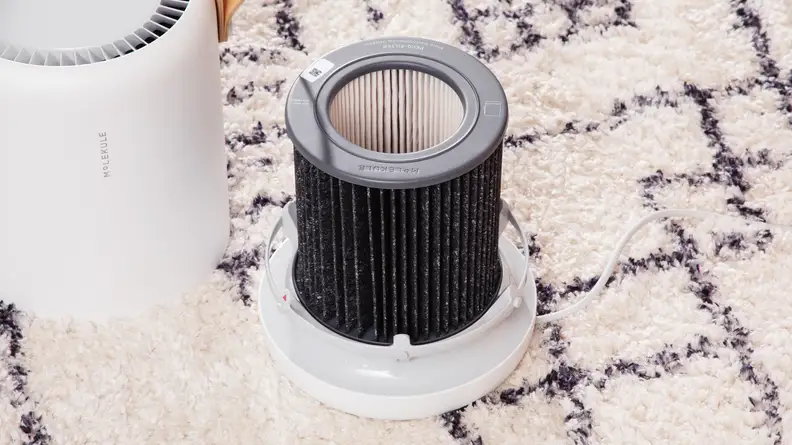 The Molekule air purifier is shown opened up, with its filter exposed.