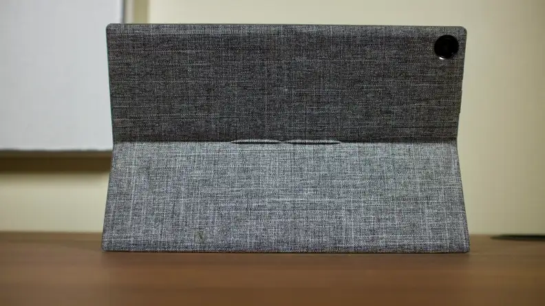 The kickstand cover, which comes in a light grey fabric finish, attached to the CM3 and extended to prop the tablet up on a desk.