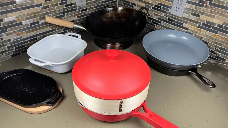 Assorted cooking pans on top of kitchen counter.