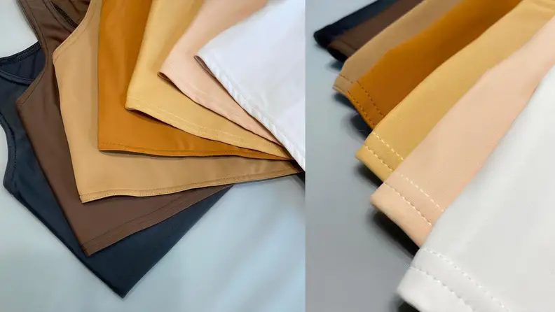 Different colored binders laid out on a white background, demonstrating the different skin-colored selection from white to black.