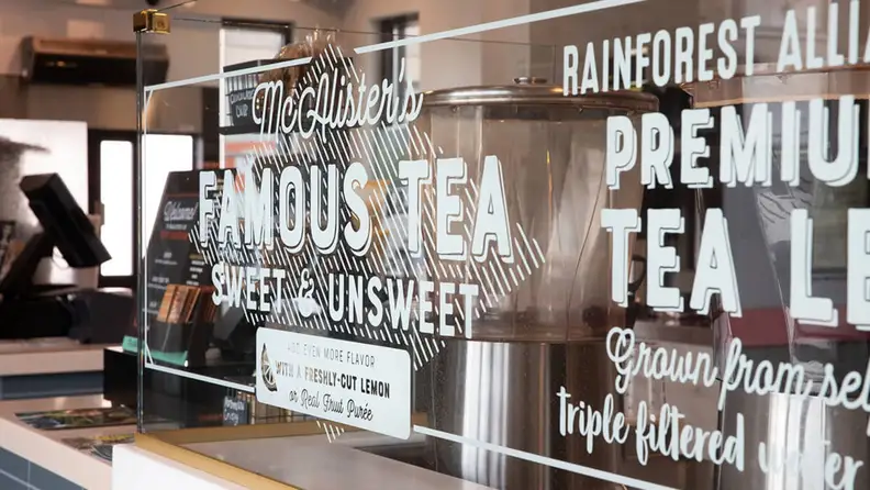 Close-up of a McAlister's counter sign advertising their famous sweet and unsweet tea