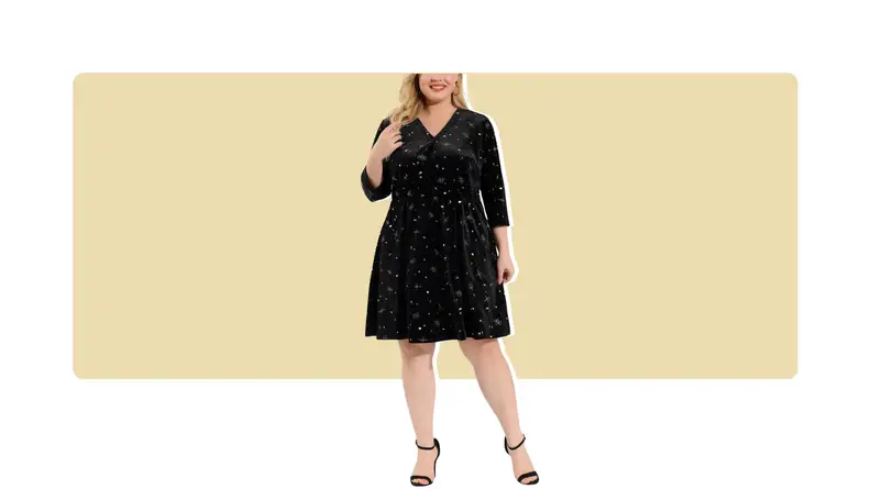 A model wearing a knee-length velvet dress with metallic star details.