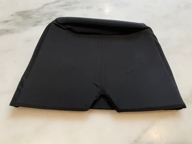 The AllSett Health Migraine Relief Cap on a marble table.