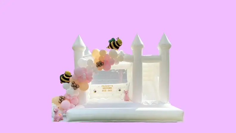A bouncy castle in front of a background.