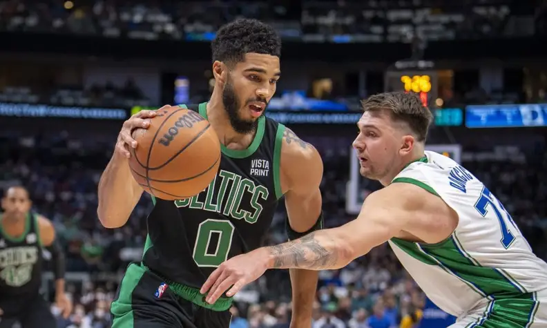 Jayson Tatum and Luka Doncic playing against one another.