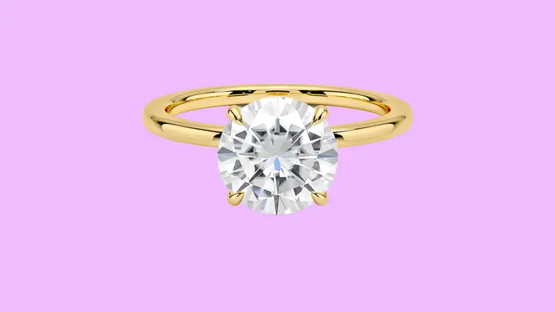 Photo of the Brilliant Earth Moissanite Secret Halo Lab Diamond Ring against a purple background.