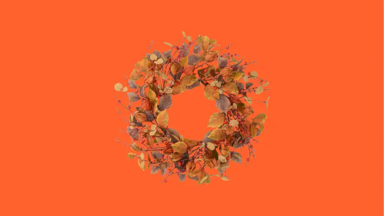Brown door wreath against orange background